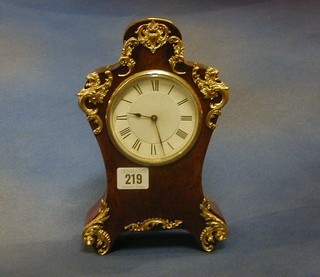 A French 8 day mantel clock contained in a shaped birds eye maple case with ormolu mounts