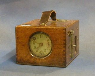 A racing pigeon clock contained in an oak case
