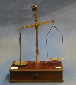 A pair of brass gold scales by Avery complete with weights