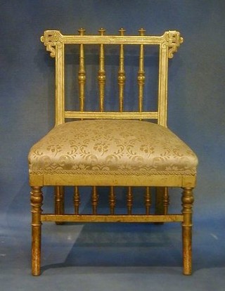 A "Regency" gilt painted dressing table stool with spindle decoration