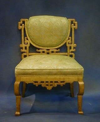 A 19th Century Oriental style pierced gilt painted dressing table stool