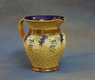 A Doulton Lambeth salt glazed jug with floral decoration, the base impressed Doulton Lambeth England 6862, incised PH (slight crack and restoration to rim 7"