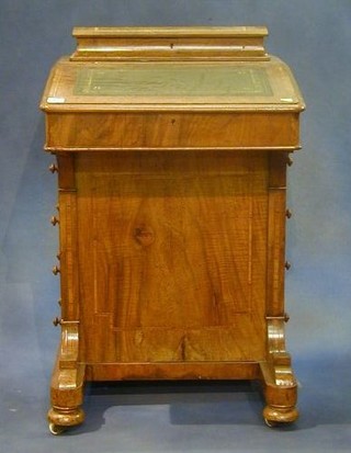A Victorian inlaid figured walnutwood Davenport desk, the top with stationery box and tooled leather writing surface, the pedestal fitted 4 long drawers 21" 53"  