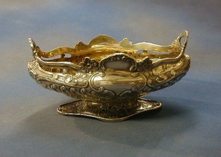 A fine quality Edwardian embossed silver boat shaped dish raised on a spreading base, London 1903, by Elkington & Co. 12", 36 ozs