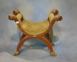 A fine quality 19th Century carved walnutwood X framed stool with lion head armrests and paw feet