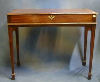 A Georgian mahogany rectangular drop flap Farmers Supper table, with hinged lid, raised on square tapering supports ending in spade feet