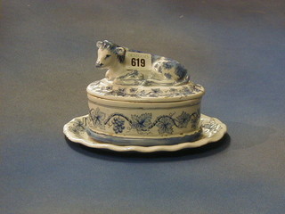 An 18th/19th Century Delft blue and white pottery cheese dish and cover the lid decorated a figure of a cow 8" 