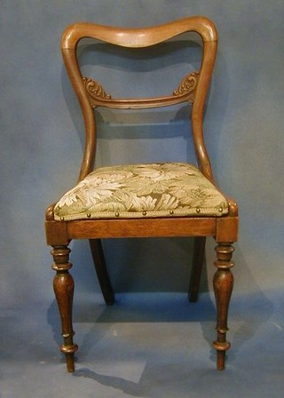 A set of 6 Victorian rosewood spoon back chairs with shaped mid-rails and upholstered drop in seats, on turned supports (some worm to the frame)