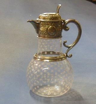 An Edwardian etched glass claret jug with embossed silver plated lid,
