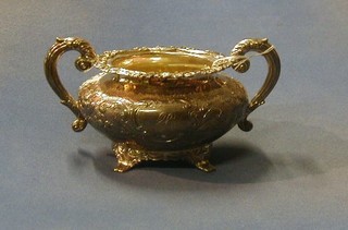 A Victorian embossed silver twin handled sugar bowl with cast borders, raised on panelled feet, London 1898