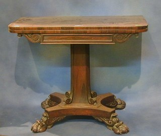 A William IV rosewood D shaped card table raised on a square chamfered column with triform base raised on scrolled feet 36"