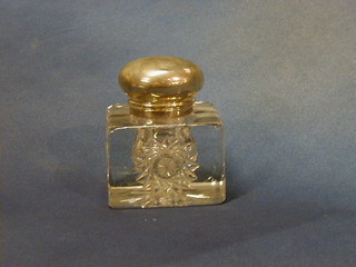 A Victorian cut glass inkwell with hinged silver lid London 1895