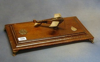 A WWI wooden and metal model of an aircraft raised on an oak stand with Royal Flying Corps cap badge and silver runners up medal Third Brigade Royal Flying Corps Football League BEF 1917