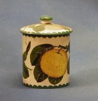A circular Wemyss pottery preserve jar decorated oranges, the base impressed Wemyss, (slight chip to top of jar) 4"