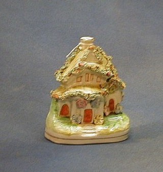 A 19th Century Staffordshire pastel burner in the form of a cottage 4"  
