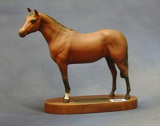 A Beswick figure of a light bay thoroughbred horse raised on an oval plaque 9"