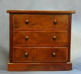 A Victorian walnutwood "apprentice" chest of 3 long drawers with tore handles, raised on a platform base 13"