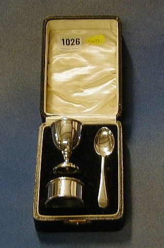 A silver egg cup, ditto napkin ring and spoon, cased