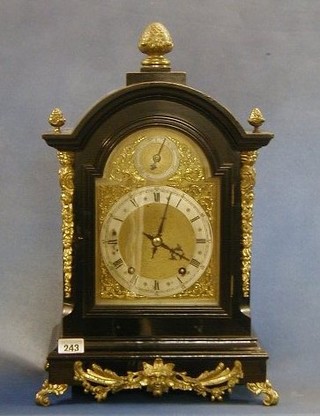 An Edwardian striking bracket clock the 6" arched brass dial with Roman numerals and silvered chapter ring contained in an ebonised and gilt mounted case  