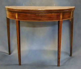 A Georgian inlaid mahogany demi-lune card table raised on square chamfered supports 38"