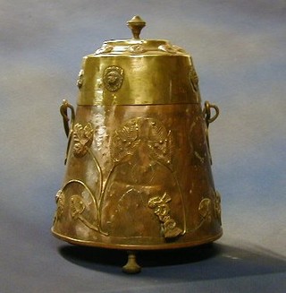 A 19th Century copper and brass Dutch coal bin raised on 3 bun supports  