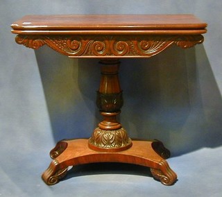 A William IV mahogany tea table with crossbanded top and carved apron, raised on a turned and carved column with triform base ending in scrolled feet  34" 
