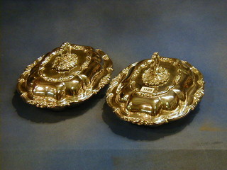 A pair of silver plated shaped entree dishes and covers