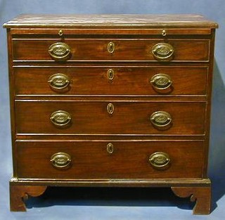 A Georgian mahogany chest with brushing slide and 4 long drawers raised on bracket feet complete with original polished steel key, 33"