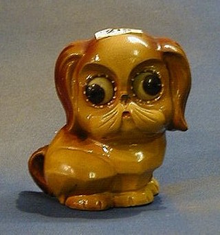 A German timepiece in the form of a seated dog, the eyes registering the time