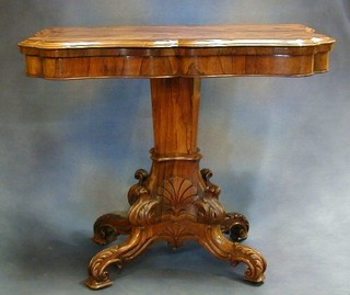 A William IV rosewood card table of serpentine outline raised on a carved chamfered column ending in 4 carved scrolled  supports 37" 
