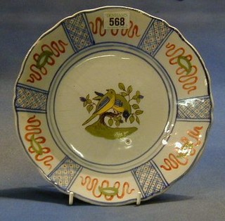 A circular faience pottery plate decorated 2 birds, the back marked 2710 France, 9" (some crackling)