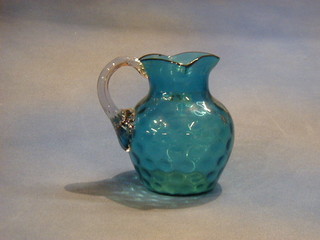 A 19th Century blue dimple patterned jug with clear glass handle
