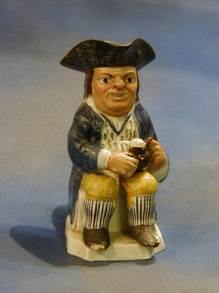 An 18th/19th Century pottery Toby jug in the form of seated Toby Philpots 9" (foot f)