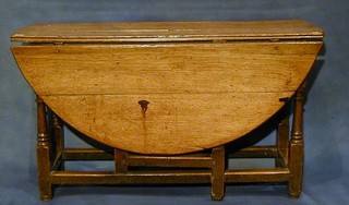 A fine quality 18th Century honey oak, oval, drop flap gateleg dining table (missing drawer) raised on turned and block supports 49"