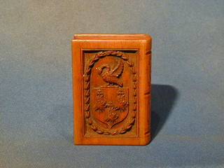 A carved wooden trinket box in the form of a book with armorial decoration 4"