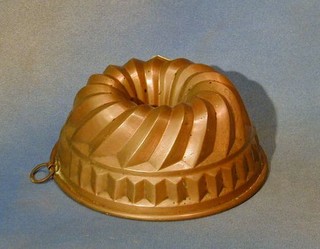 A circular copper jelly mould