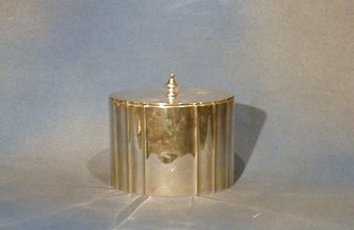 A Victorian oval silver caddy with hinged lid and armorial decoration London 1863 15 ozs