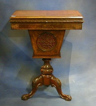 A Victorian inlaid figured walnutwood work table fitted  a deep basket and raised on pillar and tripod supports 22"