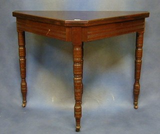 An Edwardian mahogany cricket card table raised on turned supports 38"