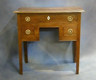 A Georgian oak low boy fitted 1 long and 2 short drawers on square tapering supports with ivory escutcheons 29"