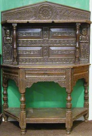 A 17th Century carved oak Credence table fitted a drawer with undertier, raised on turned supports with a later associated carved back 46"