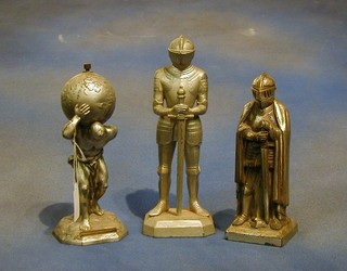 An aluminium table light in the form of Atlas and 2 other table lighters in the form of standing knights