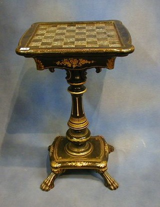 A Victorian papier mache games table, the top inlaid a chess board, fitted a drawer, raised on a baluster turned column with cushion shaped base, raised on 4 hoof supports 18"