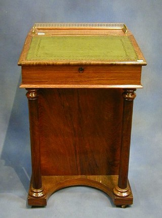 A William IV rosewood Davenport desk with pierced brass three-quarter gallery inset a tooled leather writing surface, the pedestal fitted an inkwell above 4 long drawers raised on turned columns 20"