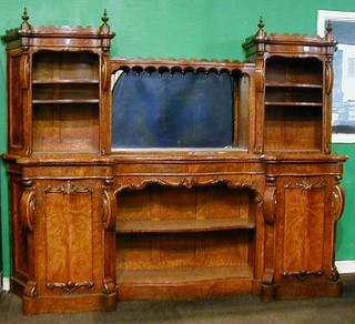 A Victorian amboyna wood sideboard with raised mirrored back flanked by 2 niches fitted shelves, the serpentine fronted base fitted a niche flanked by 2 cupboards 81" 