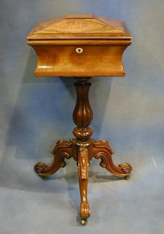 A Victorian rosewood teapoy the interior fitted mixing bowl and 2 caddies, raised on a turned and fluted column with tripod base 16"