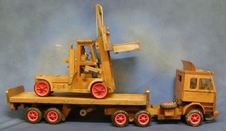 A wooden model of a Scania tractor unit and trailer together with a fork lift truck