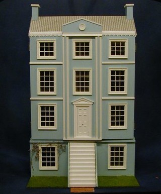 A blue painted dolls house in the Georgian manner with decorated interior, hinged doors etc