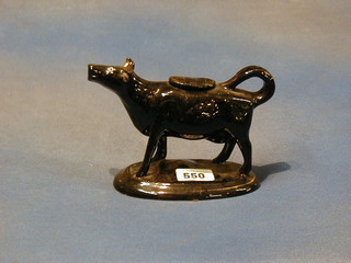A 19th Century black glazed pottery cow creamer