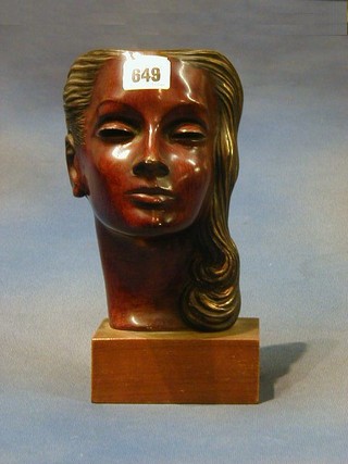 A German terracotta mask in the form of a lady raised on a wooden plinth 9"